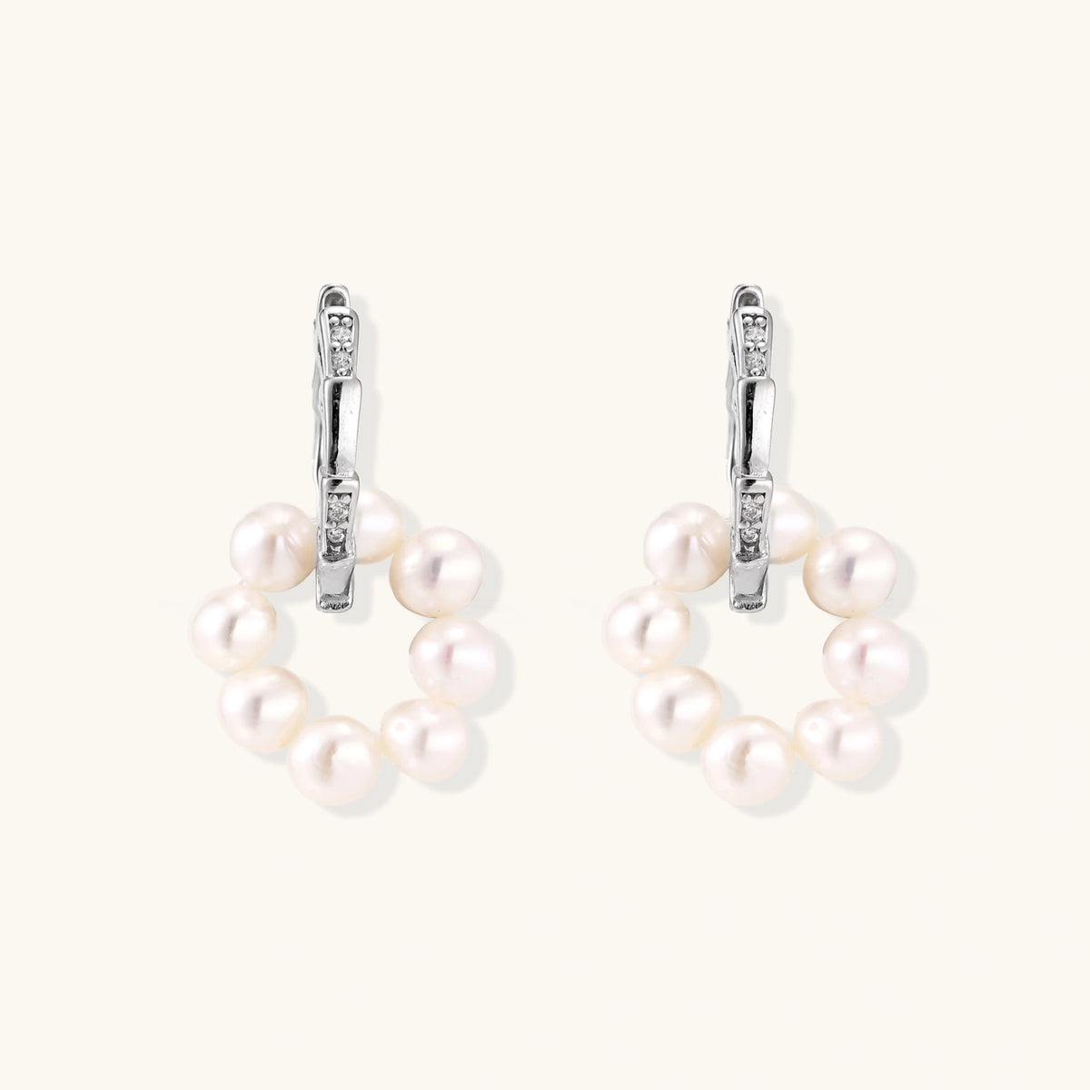 Rhodium-plated silver hoop earrings with freshwater pearls arranged in crescent formation and diamond accents