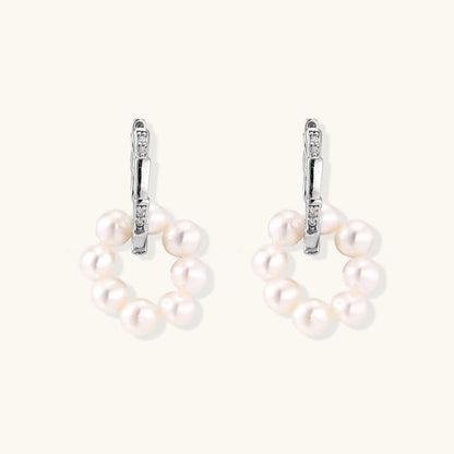 Rhodium-plated silver hoop earrings with freshwater pearls arranged in crescent formation and diamond accents