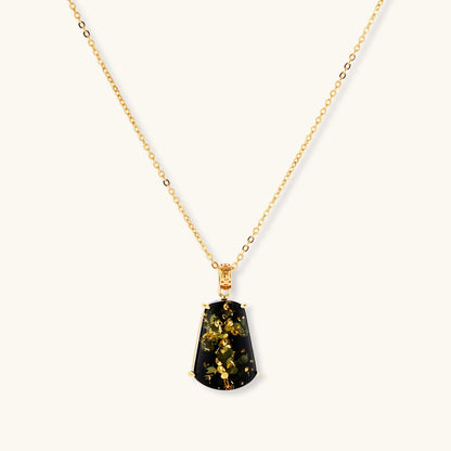 18k gold-plated necklace and earrings with green amber pendants featuring golden inclusions on cream background